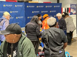 People interacting at a Johns Hopkins Advantage MD information booth during an event.